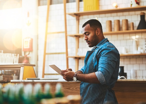 a small business owner looking at their tablet